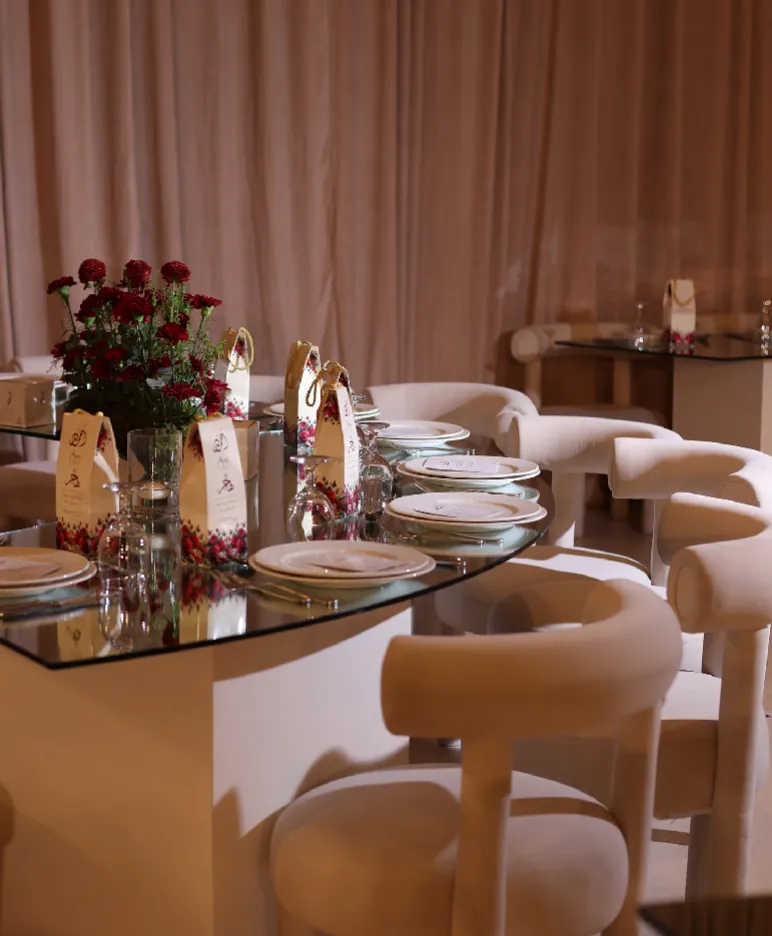 Glass dining table with roses and place settings