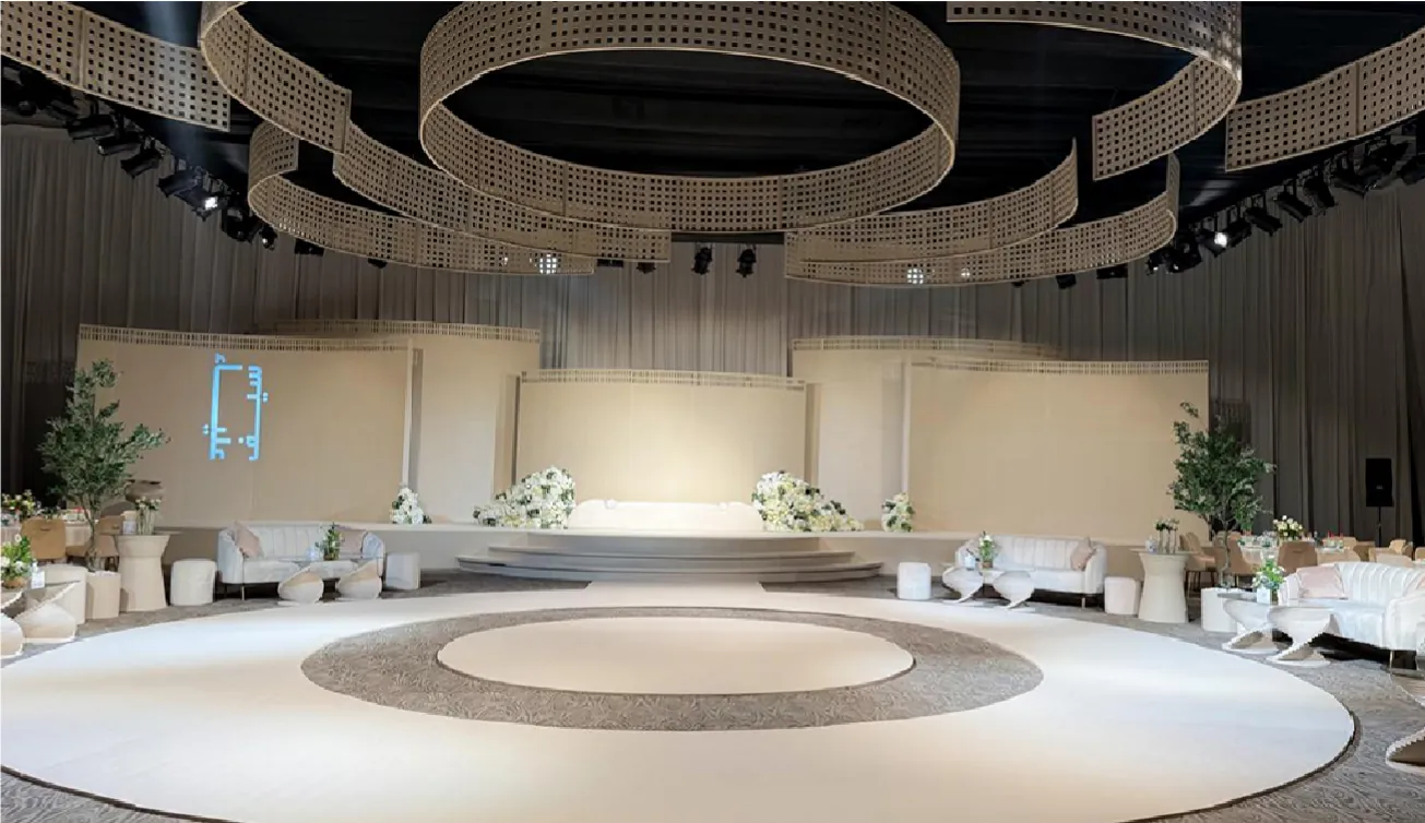 Circular wedding stage under suspended perforated rings
