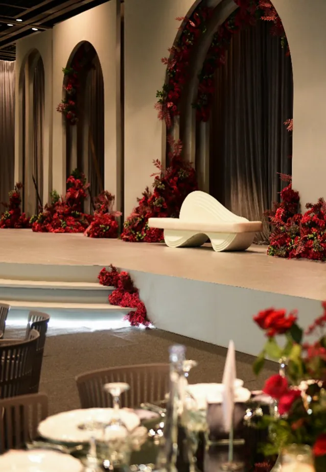 Bridal stage with red rose arches by Bride Dream Events