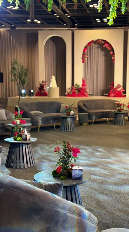 Lounge seating in front of floral arches