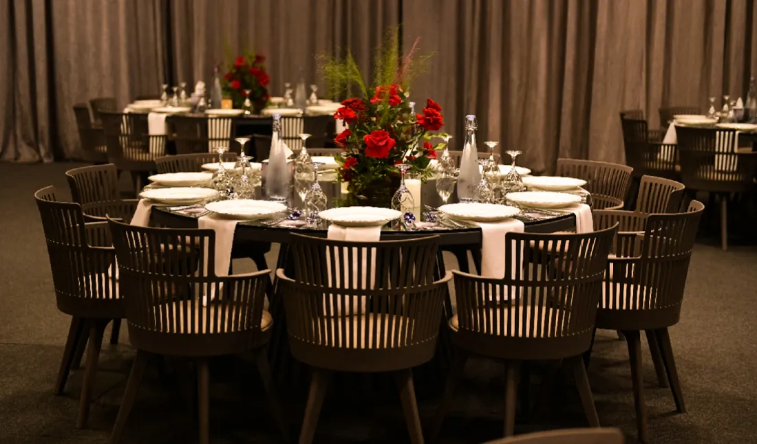Guest tables with red rose centrepieces